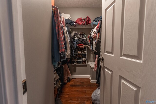 bedroom with crown molding, dark wood-type flooring, and ceiling fan