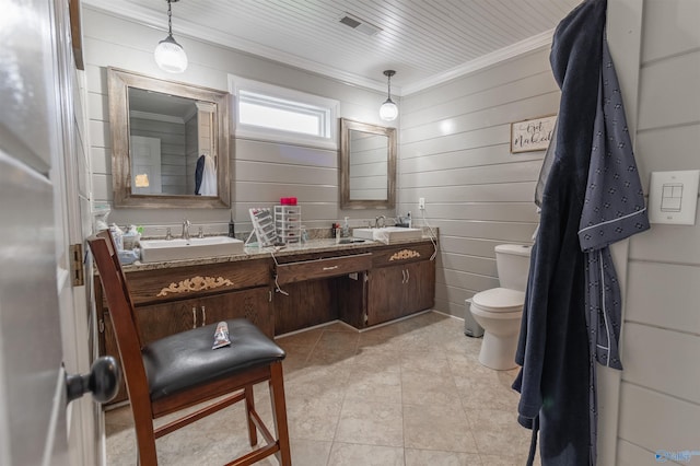 full bathroom featuring toilet, crown molding, a sink, and tile patterned floors