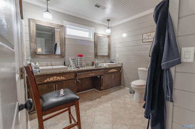 bathroom with wood walls, toilet, tile patterned floors, and double sink vanity