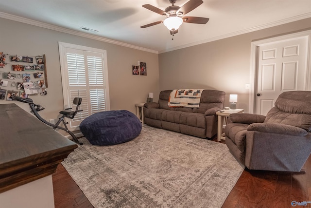 living area with ornamental molding, visible vents, ceiling fan, and dark wood-style floors