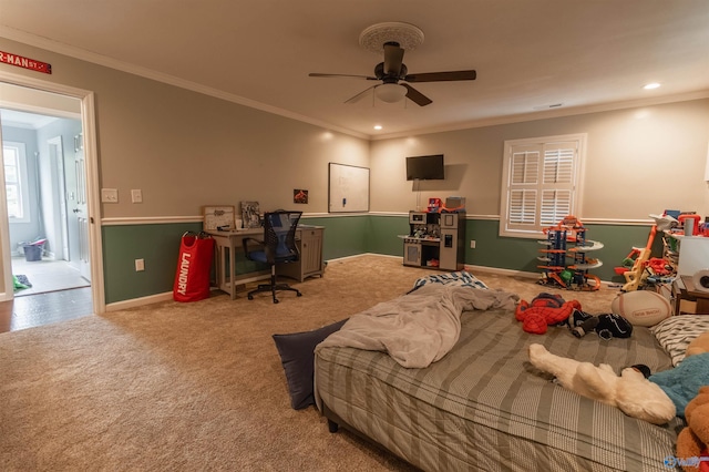 carpeted bedroom with crown molding and ceiling fan