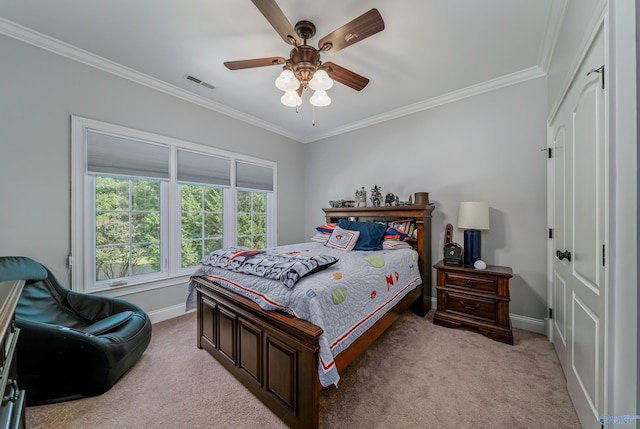 bedroom featuring a closet, ceiling fan, light colored carpet, and ornamental molding