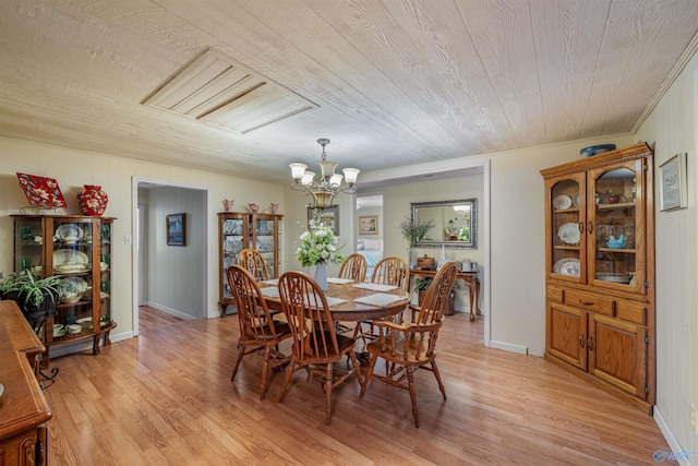 dining space with a chandelier, wooden ceiling, light wood finished floors, and baseboards