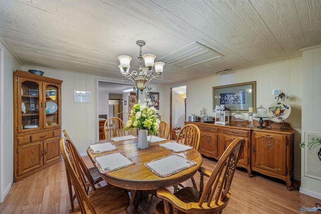 dining space featuring visible vents, a notable chandelier, wooden ceiling, and light wood-style floors