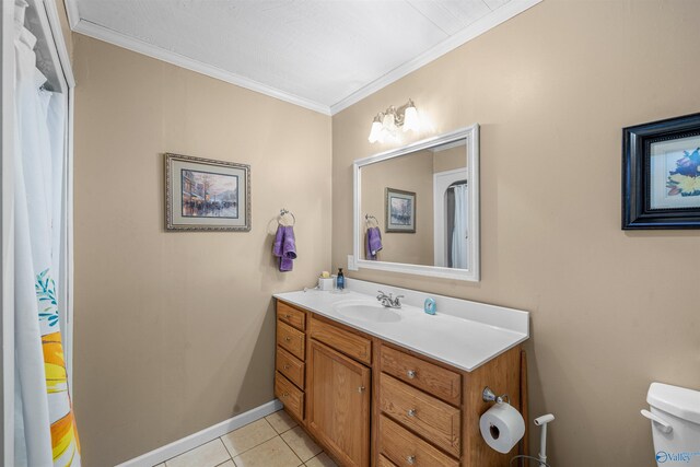 full bathroom with vanity, toilet, crown molding, baseboards, and tile patterned flooring