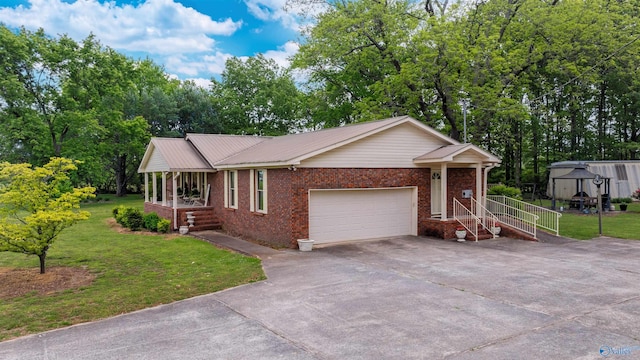 single story home with brick siding, metal roof, a garage, a front lawn, and concrete driveway