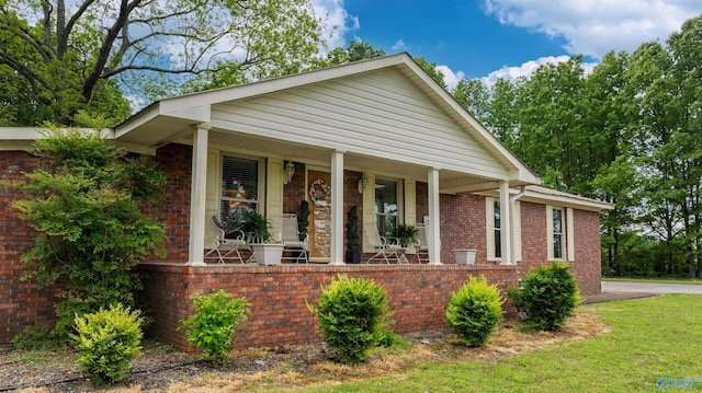 view of front of property with covered porch and brick siding