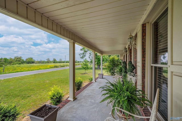 view of patio featuring a rural view and covered porch