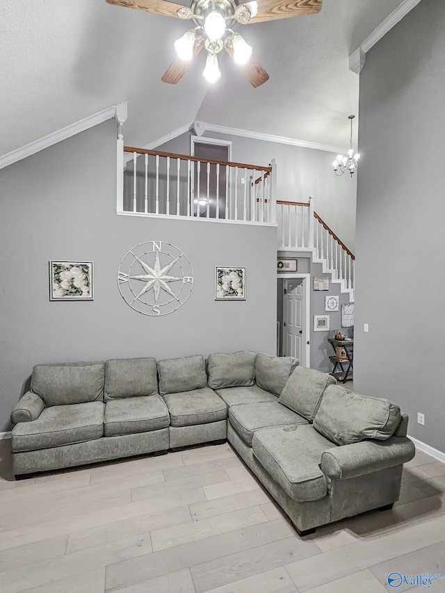 living room featuring crown molding, high vaulted ceiling, ceiling fan with notable chandelier, and light wood-type flooring