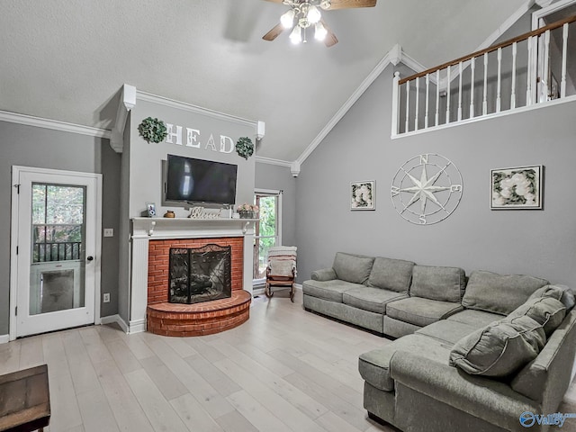 living room featuring light hardwood / wood-style flooring, plenty of natural light, and ornamental molding