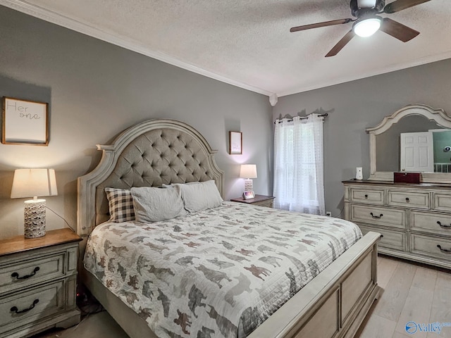 bedroom with ceiling fan, light hardwood / wood-style flooring, a textured ceiling, and ornamental molding