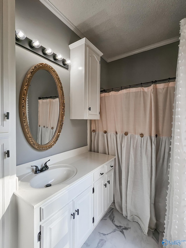 bathroom featuring crown molding, vanity, and a textured ceiling