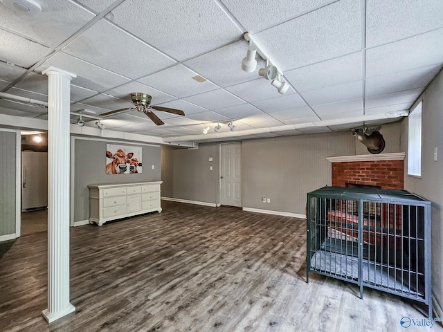 basement featuring wood-type flooring, a drop ceiling, and ceiling fan