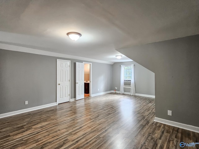 bonus room with dark hardwood / wood-style floors