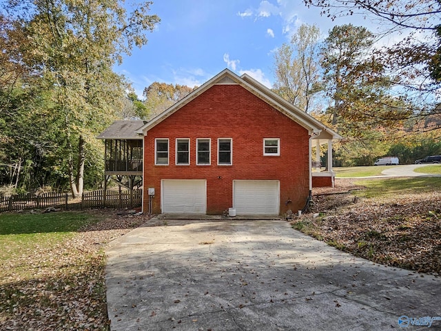 view of property exterior with a sunroom and a garage