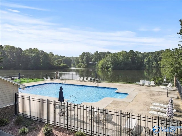 view of pool with a water view and a patio