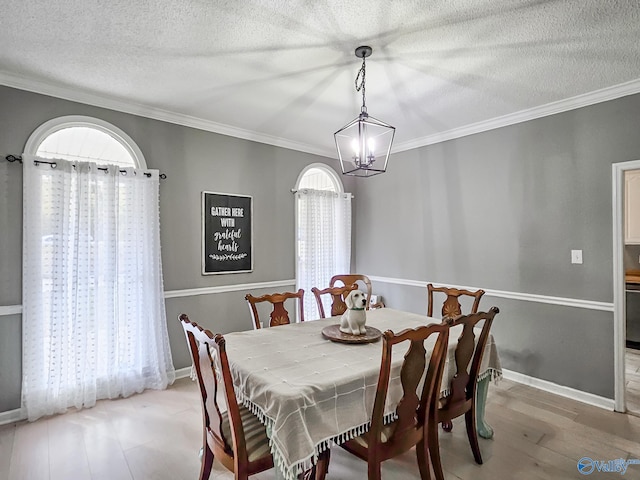 dining room with crown molding, a textured ceiling, and a notable chandelier