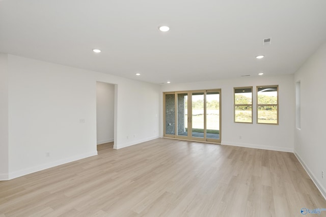 spare room featuring visible vents, recessed lighting, light wood-type flooring, and baseboards