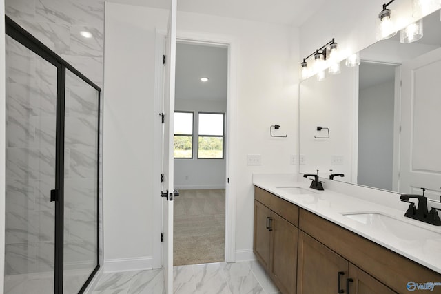 bathroom featuring double vanity, marble finish floor, a marble finish shower, and a sink