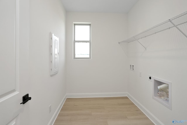 clothes washing area featuring hookup for a washing machine, baseboards, hookup for an electric dryer, laundry area, and light wood-type flooring