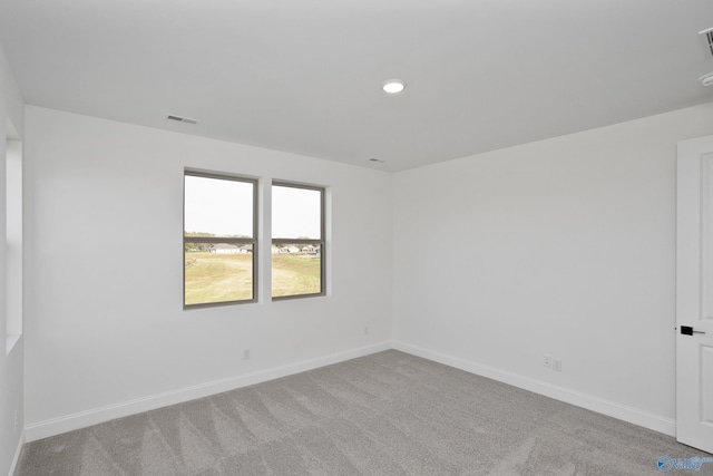 carpeted empty room with recessed lighting, visible vents, and baseboards