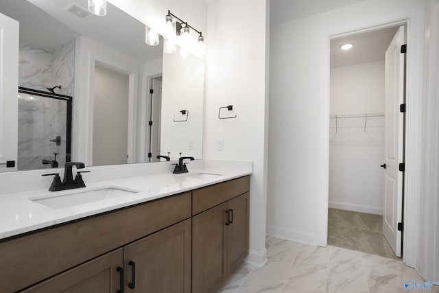 full bath featuring a sink, a marble finish shower, marble finish floor, and visible vents