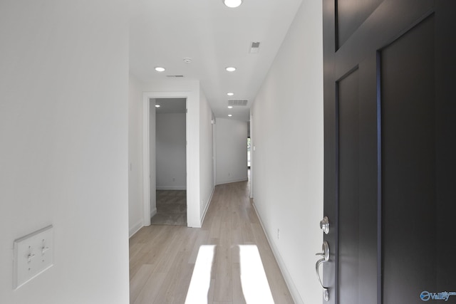 hall featuring baseboards, recessed lighting, visible vents, and light wood-type flooring