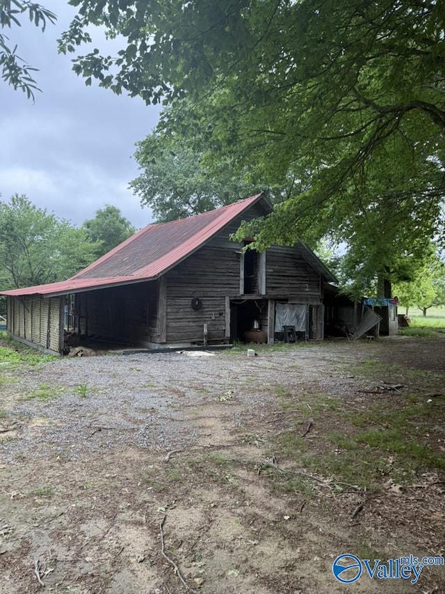 1522 County Road 138, Rainsville, AL 35978 - view of home's exterior featuring metal roof, an outdoor structure, and a barn