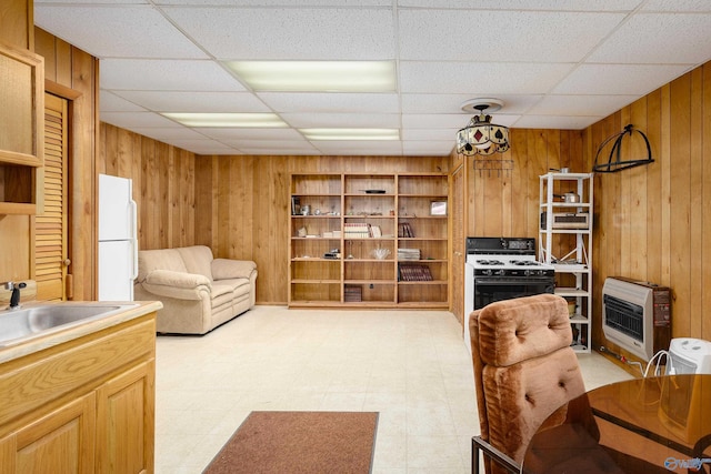 living room with light floors, wood walls, and heating unit