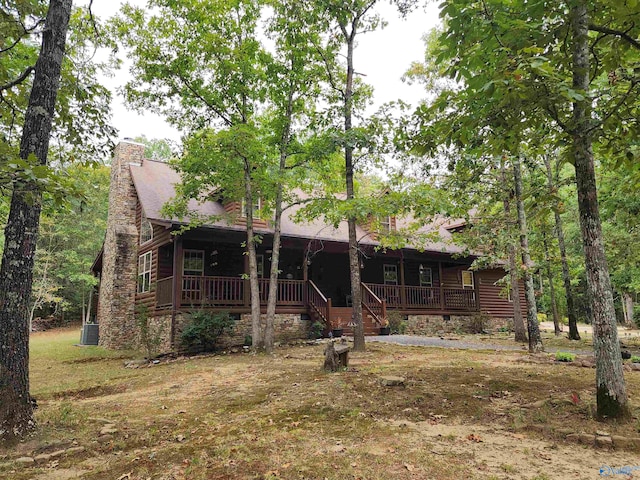 rear view of house featuring a wooden deck and central AC unit