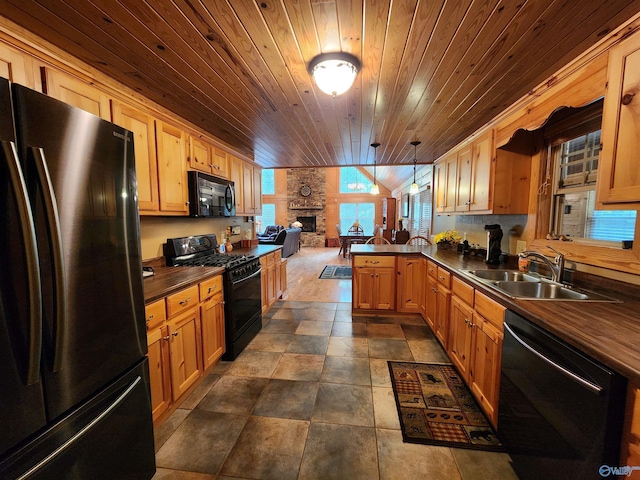 kitchen with a fireplace, wood ceiling, sink, black appliances, and kitchen peninsula