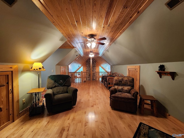 living area with light wood-type flooring, lofted ceiling, and ceiling fan