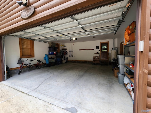 garage featuring a garage door opener and water heater