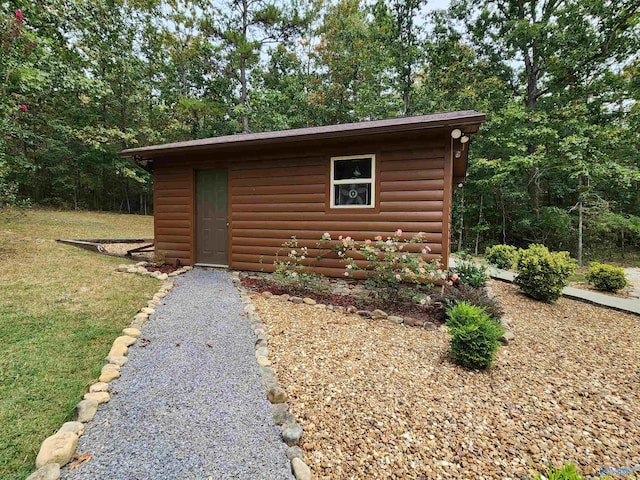 view of outbuilding featuring a yard