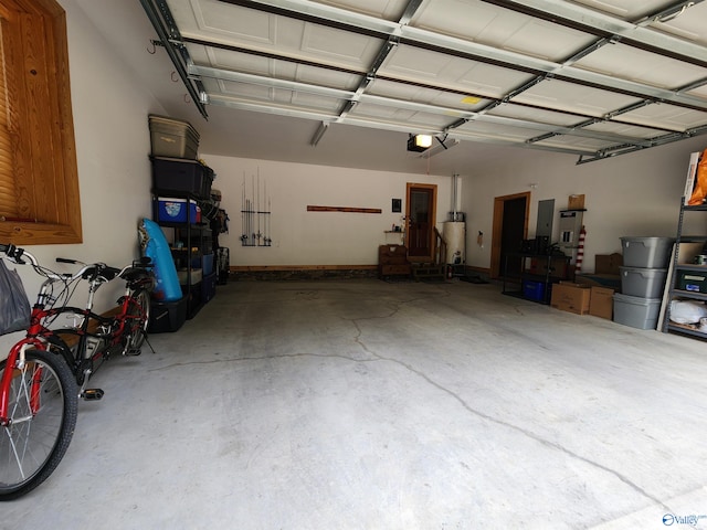 garage with gas water heater and a garage door opener