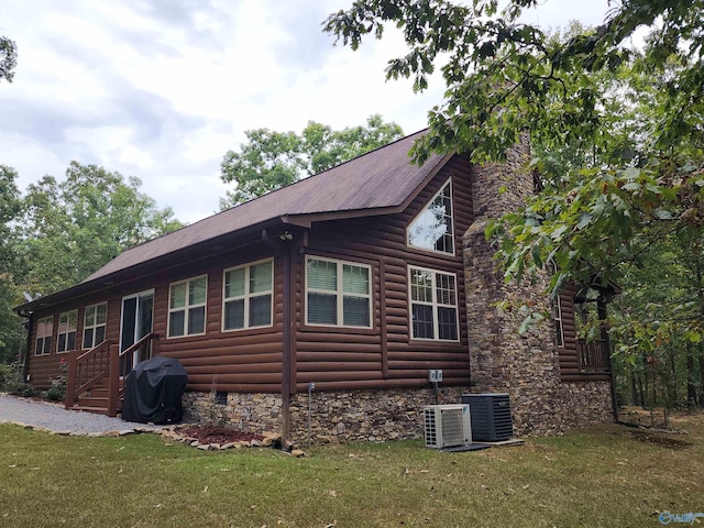 view of property exterior featuring a lawn and central AC