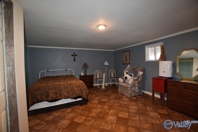 bedroom featuring crown molding and baseboards