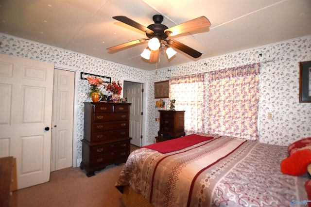 carpeted bedroom with ceiling fan and wallpapered walls