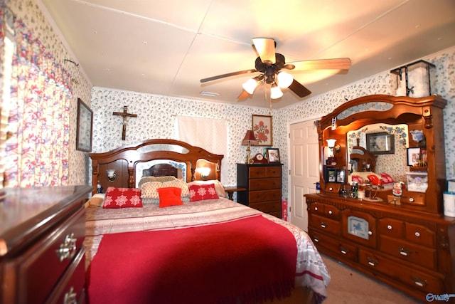 carpeted bedroom with visible vents, ceiling fan, and wallpapered walls