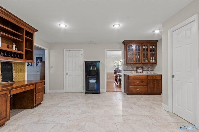 kitchen featuring open shelves, recessed lighting, decorative backsplash, glass insert cabinets, and baseboards