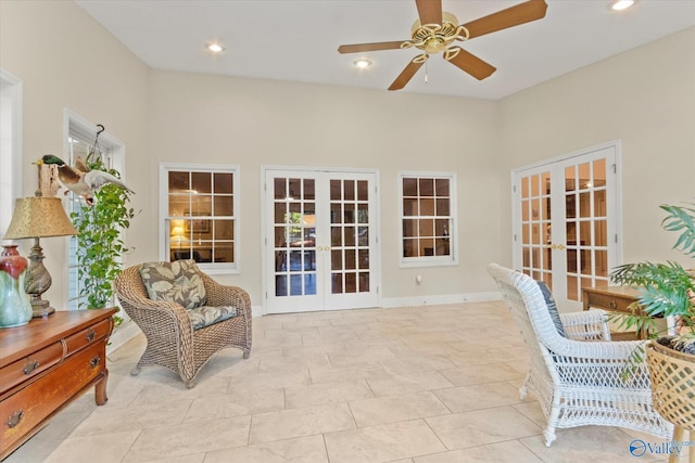 living area featuring light tile patterned flooring, recessed lighting, a ceiling fan, baseboards, and french doors