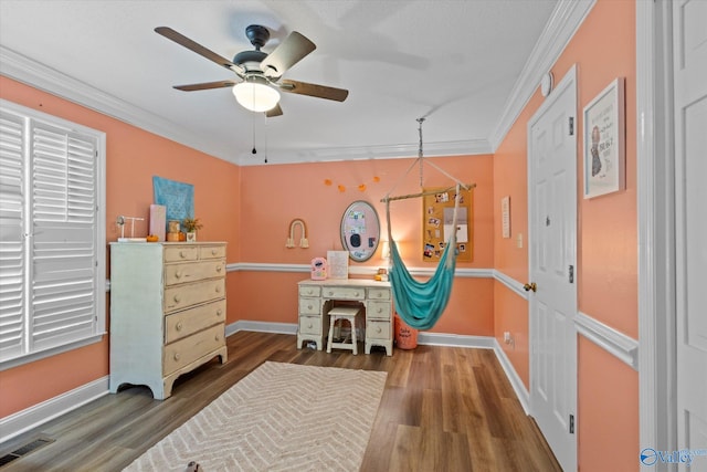 bedroom with crown molding, ceiling fan, and dark hardwood / wood-style flooring