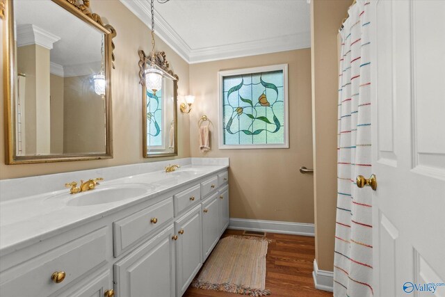 bathroom with crown molding, a healthy amount of sunlight, and wood-type flooring