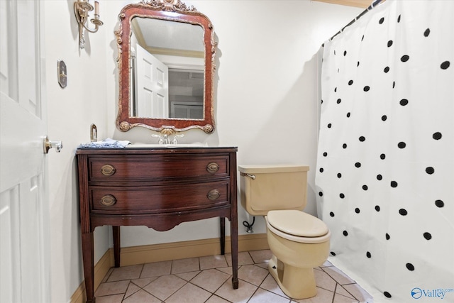 bathroom featuring a shower with shower curtain, vanity, toilet, and tile patterned floors