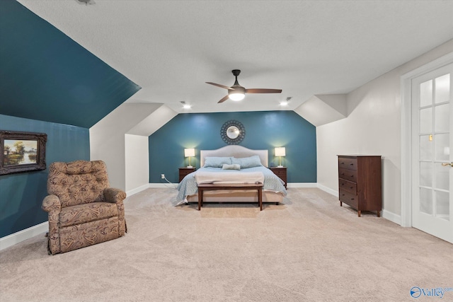 bedroom featuring lofted ceiling, ceiling fan, carpet, and a textured ceiling