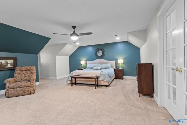 bedroom with vaulted ceiling, light colored carpet, and ceiling fan