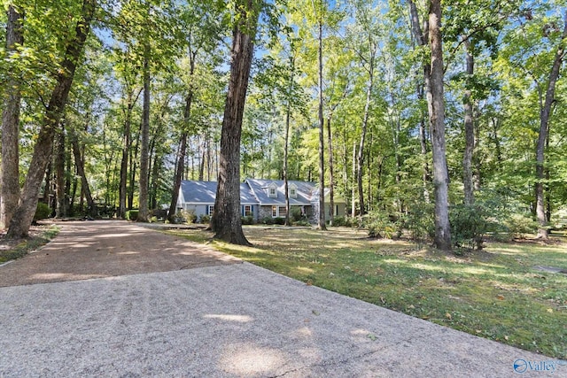 view of front of property with driveway and a front lawn