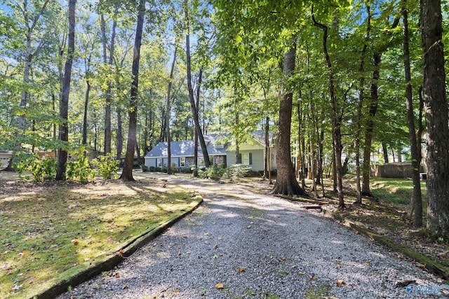 view of front of home featuring gravel driveway and fence