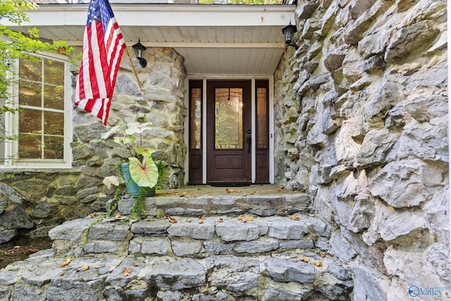 property entrance featuring stone siding