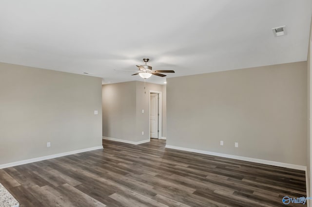 unfurnished room featuring visible vents, a ceiling fan, baseboards, and dark wood-style flooring